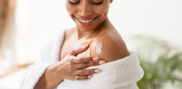 Woman Applying Lotion On Shoulders