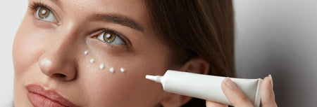 Beautiful Woman Applying Eye Cream